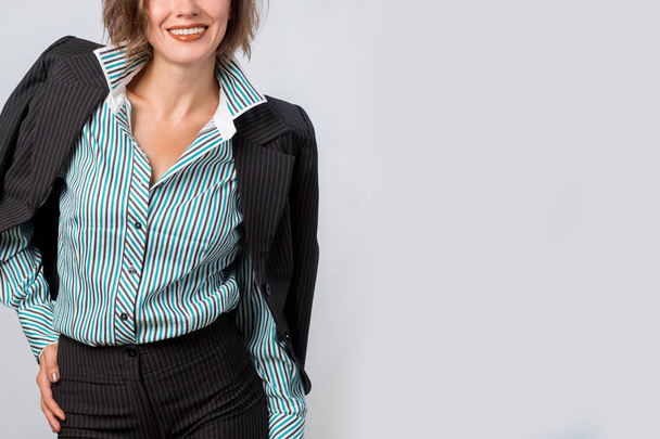 Office worker. Photo working woman in suit over grey background - Photo, Image
