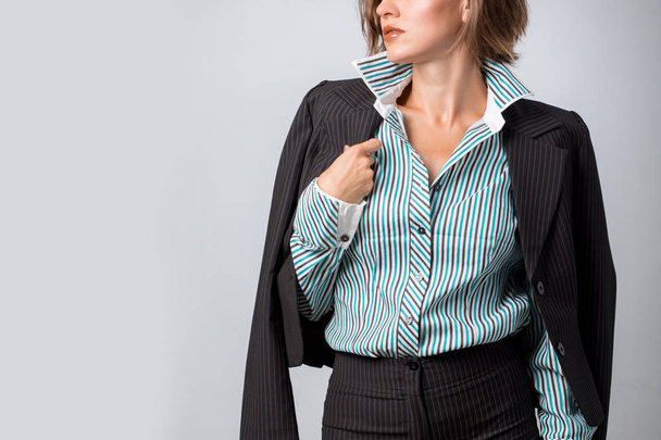 Office worker. Photo working woman in suit over grey background - Zdjęcie, obraz