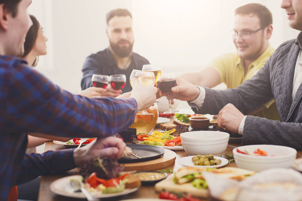 People say cheers clink glasses at festive table dinner party - Foto, Imagen