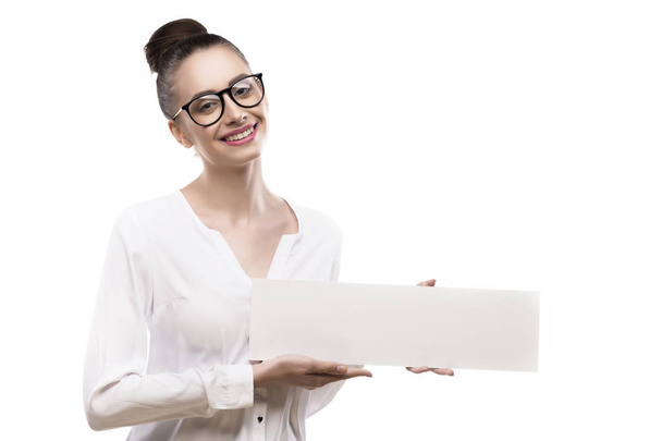 office girl holds in hands blank white plate on a white backgrou - 写真・画像