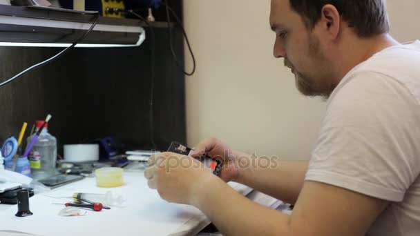 Hombre maestro desmontaje de teléfono inteligente para el cambio de detalles rotos
 - Imágenes, Vídeo
