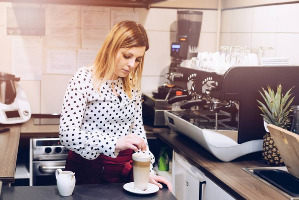 Woman barista making latte art at cafe. - 写真・画像