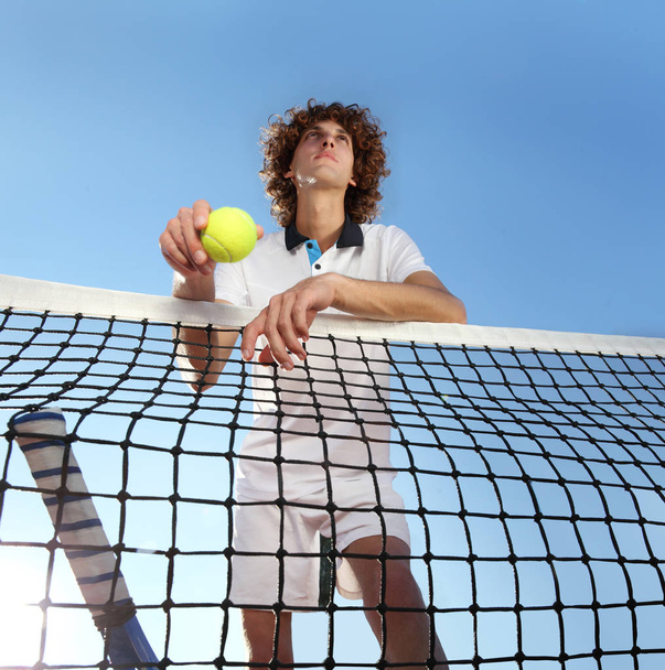 tennista con racchetta e palla in piedi davanti alla rete
 - Foto, immagini
