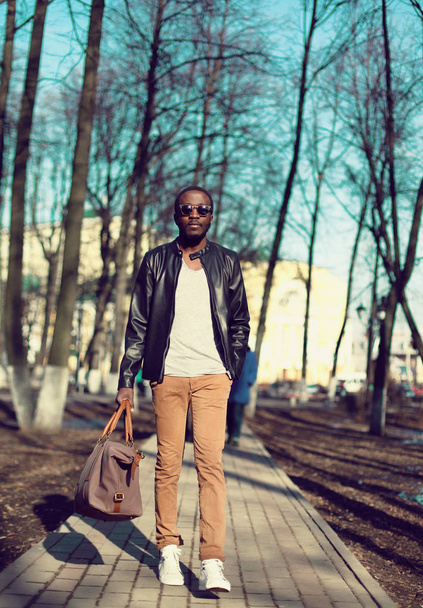 Fashion african man model wearing a black leather jacket with ba - Фото, изображение
