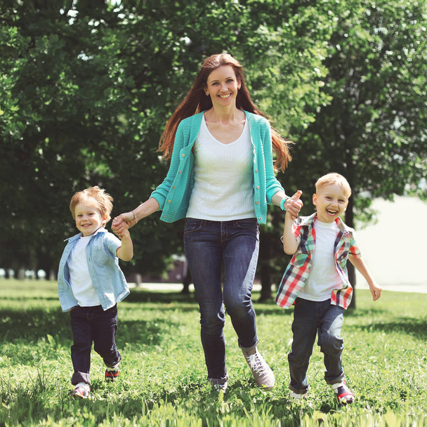 Happy family is having fun, mother and two children sons playing - Photo, image