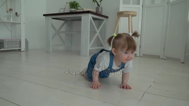 Adorable smiling baby crawling on floor towards the camera - Záběry, video