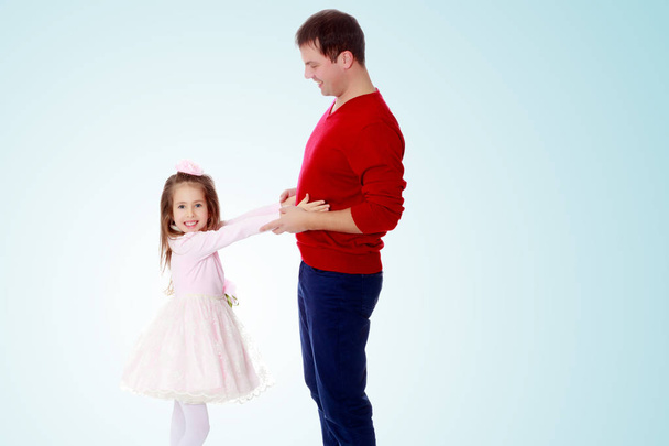 Little girl pulls her hands to his daddy. - Foto, Bild