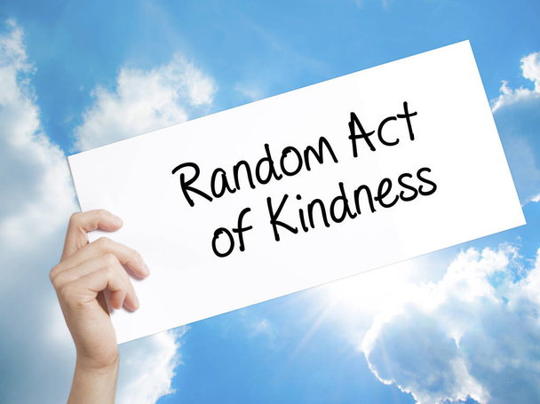 Random Act of Kindness Sign on white paper. Man Hand Holding Pap - Photo, Image