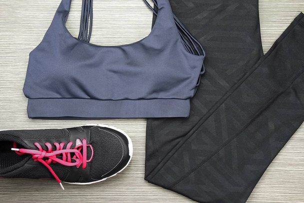 Sport accessories and fashion, Grey Women's sports bra and sneakers. Healthy lifestyle. - Photo, Image
