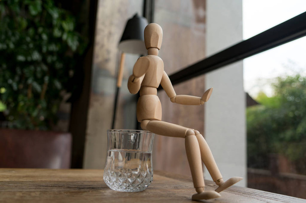 Holzmann sitzt auf einem Glas Wasser - Foto, Bild