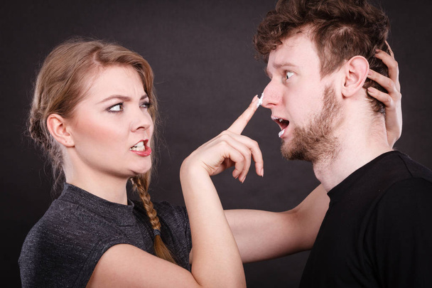 Woman applying cream to her man face. - Foto, imagen