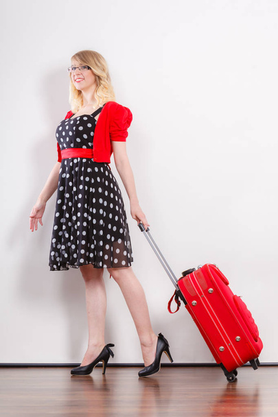 Elegant fashion woman with red suitcase - Foto, afbeelding