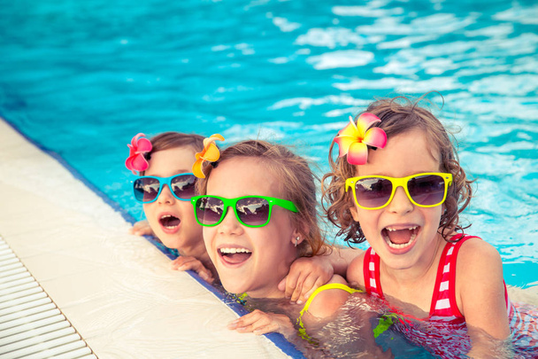 Happy children in the swimming pool - Фото, зображення
