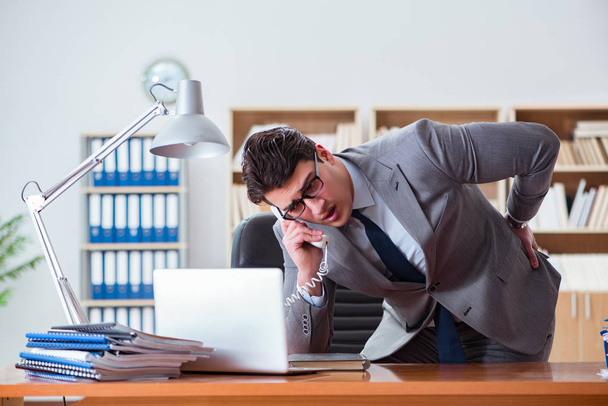 Businessman feeling pain in the office - Photo, Image