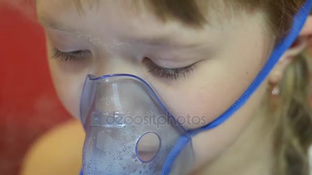 sad kid in hospital breathing mask for inhalation, girl in hospital is treated by inhalation. - Footage, Video
