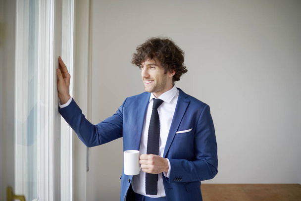 businessman drinking a morning coffe - Фото, изображение
