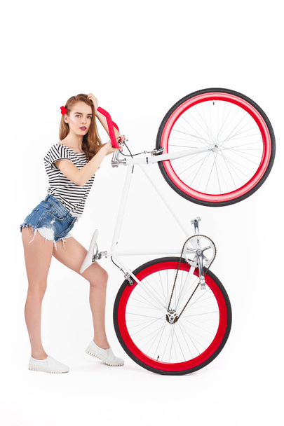 Woman holding bicycle up - Foto, imagen