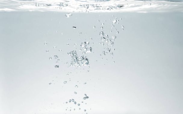 fresh fizzy water in the glass with bubbles background, close up view, health, diet nutrition  - Photo, image