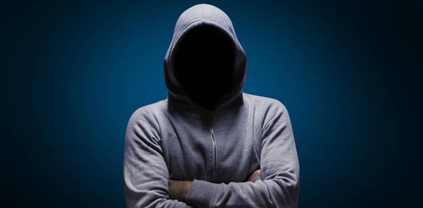 Composite image of hacker standing with arms crossed  - Foto, afbeelding