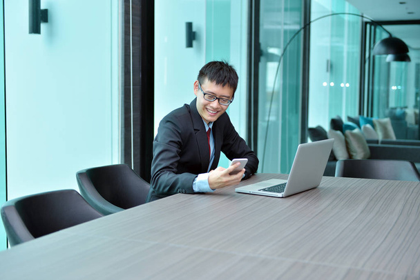 Asian Businessman using smartphone in a conference room - Fotó, kép