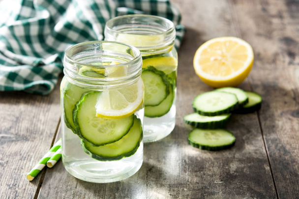 Detox water with cucumber and lemon on wooden table - Photo, Image