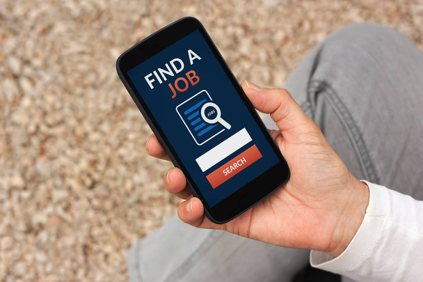 Hand holding smart phone with find a job concept on screen - Foto, Imagen