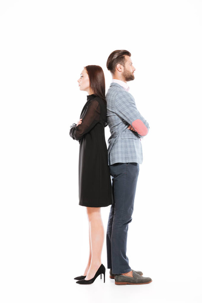 Offended serious loving couple standing isolated - 写真・画像