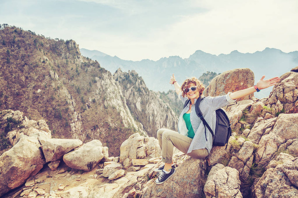 Happy young woman traveler in the mountains enjoying the view. F - Photo, Image