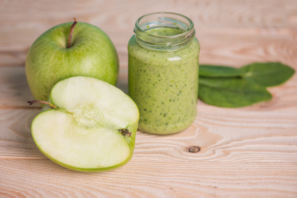 apple with green leaves and smoothie in jar - Photo, Image