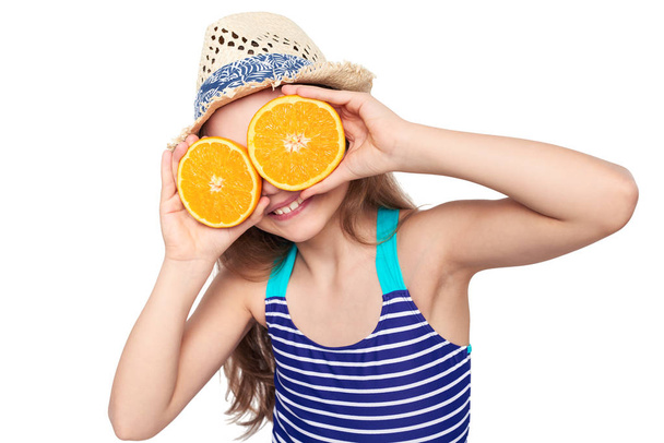 Girl in swimsuit making fake eyeglasses with oranges - Foto, afbeelding