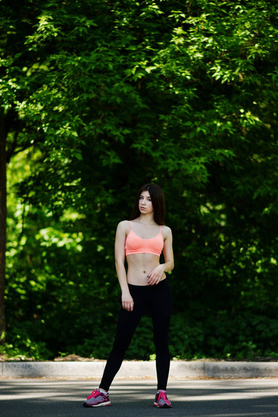 Fitness sport girl in sportswear posed at road in park, outdoor  - Foto, Imagem