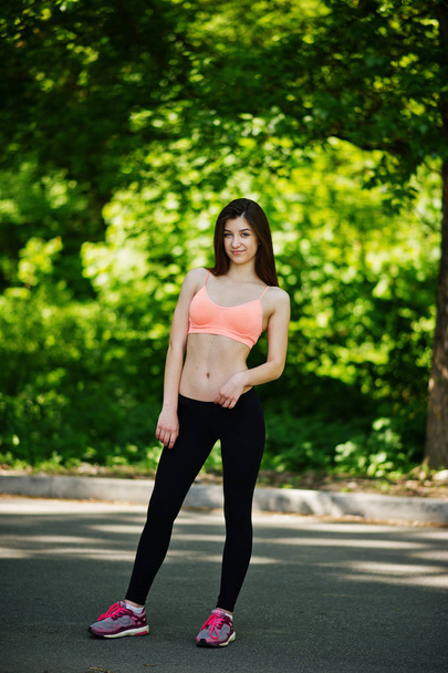 Fitness sport girl in sportswear posed at road in park, outdoor  - Foto, Imagem