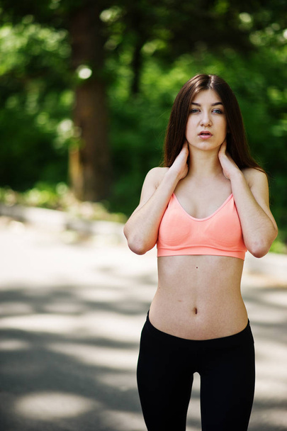 Fitness slim sexy sport girl in sportswear posed in road at park - Foto, Bild