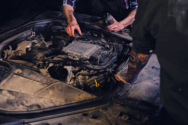 Two mechanics fixing car's engine  - Photo, Image