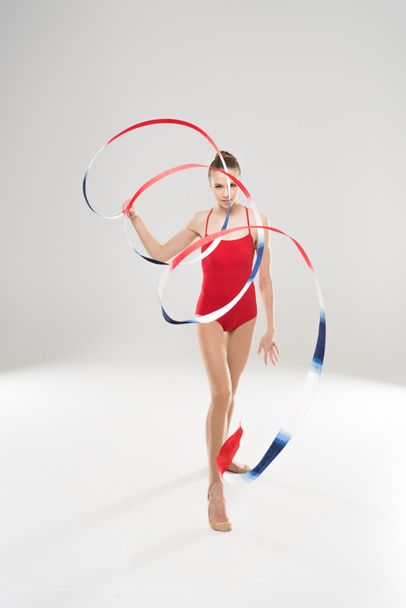 woman rhythmic gymnast walking with rope - Foto, imagen
