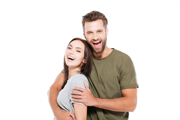 Cheerful young loving couple standing isolated - Foto, Bild