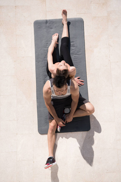woman with personal trainer doing morning yoga  - Zdjęcie, obraz