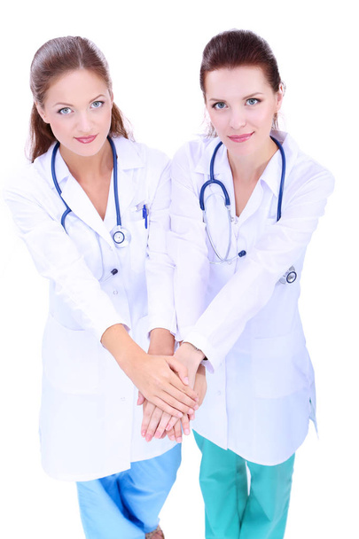 Doctors and nurses stacking hands. Isolated on white background - Foto, immagini