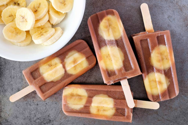 Chocolate banana popsicles on rustic grey background - Photo, Image