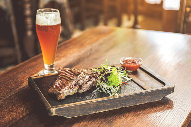 Spicy meat with light cold beer - 写真・画像