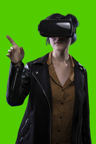 Woman Wearing a VR Headset on a Green Screen Background - 写真・画像
