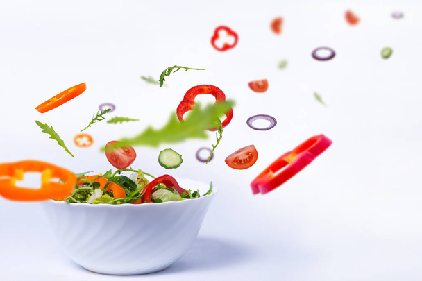 salad with flying vegetables - Photo, Image