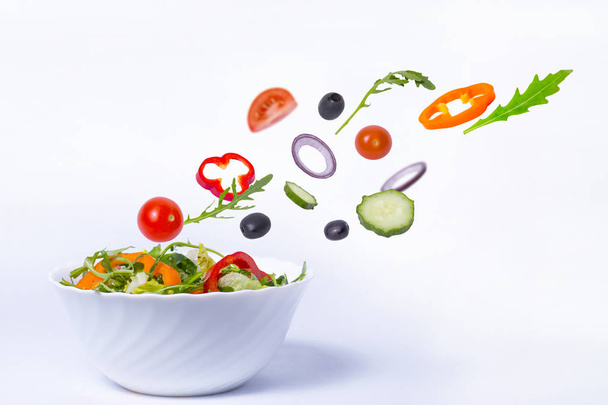 salad with flying vegetables - Фото, зображення