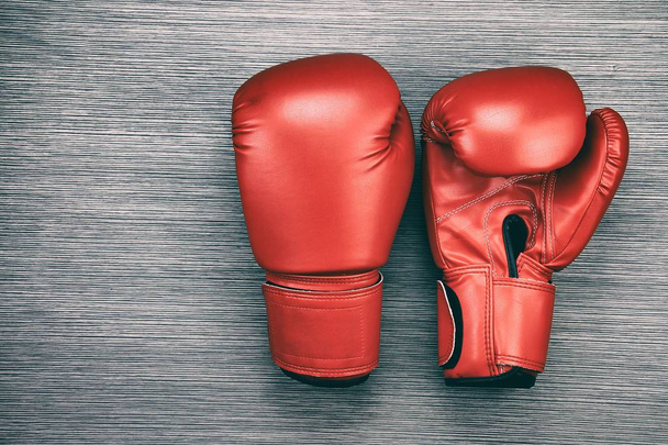 Pair of red leather boxing gloves on wooden background. - Photo, Image