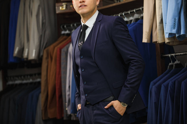 Handsome elegant young fashion man in classical costume suit. Advertising photo - 写真・画像