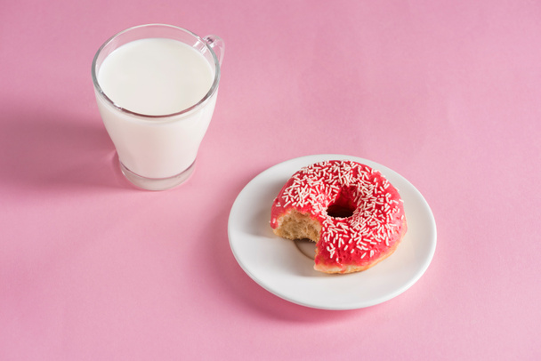 glass cup of milk with donut on plate - Фото, зображення