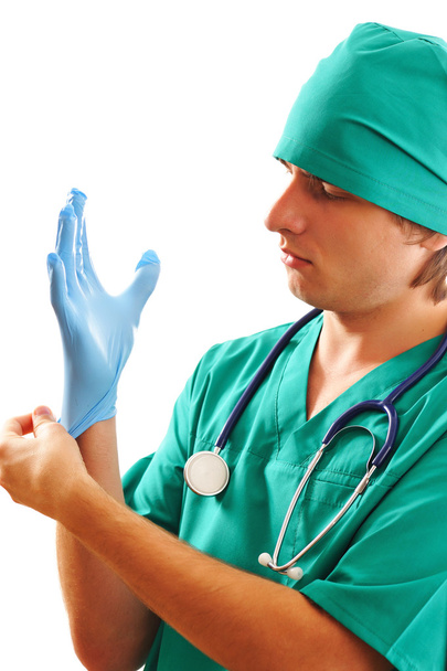 Pulling on surgical glove - Zdjęcie, obraz