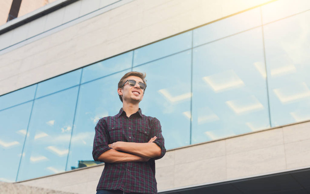 Young man standing at modern office - Photo, Image