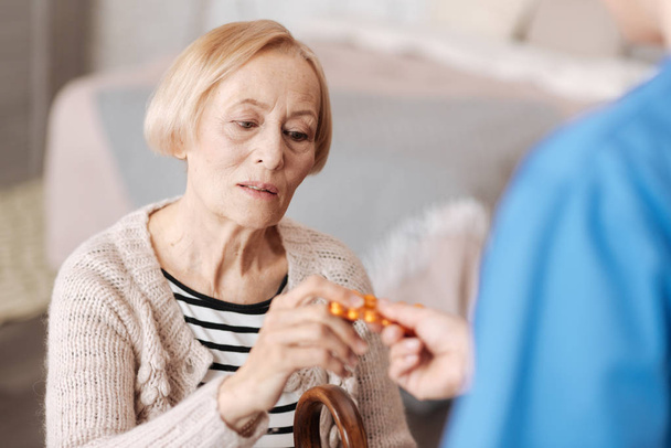 Frail fragile mature woman having the pills prescribed - Фото, изображение