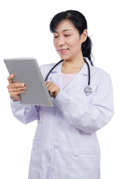 Asian female doctor holding a tablet - Valokuva, kuva